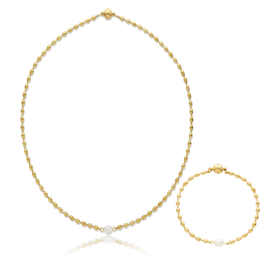 A gold necklace and matching bracelet set, each featuring a small white pearl accent, displayed on a clean white background with a subtle reflection.