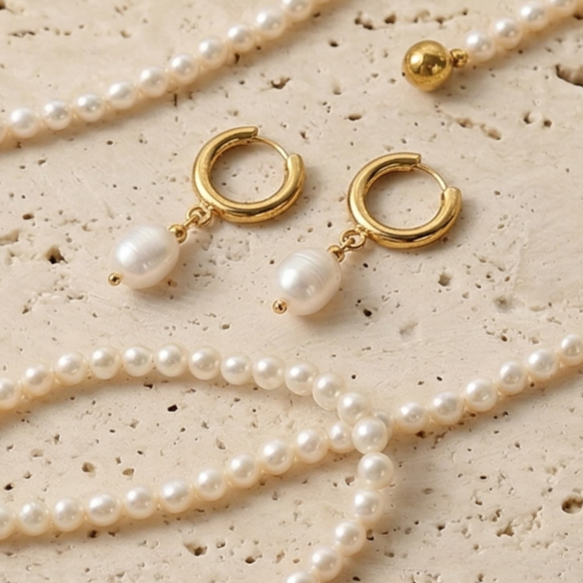 Gold hoop earrings with freshwater pearl drops by Avean Jewellery